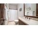 Bathroom with a sink, marble countertop, bronze hardware, and a shower with a white shower curtain at 2330 N Channing --, Mesa, AZ 85207