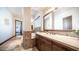 Hallway bathroom showcasing travertine flooring, vanity with a granite countertop, and a soaking tub at 2330 N Channing --, Mesa, AZ 85207