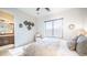 Well-lit bedroom featuring a queen size bed, a comfortable chair, and an ensuite bathroom at 2330 N Channing --, Mesa, AZ 85207