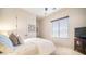 Brightly lit bedroom with a queen bed, soft carpet, and a window with blinds at 2330 N Channing --, Mesa, AZ 85207