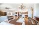 Open-concept dining room featuring wood table, decorative chandelier, and seamless flow into the kitchen and living area at 2330 N Channing --, Mesa, AZ 85207