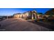 Paver driveway showcasing three-car garage and stone exterior accents with manicured landscaping at 2330 N Channing --, Mesa, AZ 85207