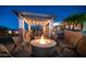 Outdoor seating featuring a pergola and a stone fire pit at 2330 N Channing --, Mesa, AZ 85207