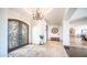 Elegant foyer features a decorative wrought iron front door and travertine flooring with neutral colored area rug at 2330 N Channing --, Mesa, AZ 85207