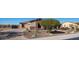 Single story home with a desert landscape, pavers, a stone facade, and a three car garage at 2330 N Channing --, Mesa, AZ 85207
