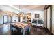 Open-concept game room featuring a pool table under an elegant chandelier, and hardwood floors at 2330 N Channing --, Mesa, AZ 85207