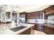 Gourmet kitchen with granite countertops, dark wood cabinets, stainless steel appliances, and tile backsplash at 2330 N Channing --, Mesa, AZ 85207