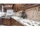 Kitchen counter features marble backsplash, dark wood cabinets, stainless steel appliances, and beverage center at 2330 N Channing --, Mesa, AZ 85207