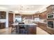 Gourmet kitchen with dark wood cabinetry, stainless steel appliances, and a large center island with seating at 2330 N Channing --, Mesa, AZ 85207