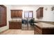 Laundry room featuring wooden cabinets, granite countertops, stainless steel washer and dryer, and tile flooring at 2330 N Channing --, Mesa, AZ 85207