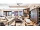 Bright living room with a corner stone fireplace, plush sectional sofa, and view to the outdoor patio at 2330 N Channing --, Mesa, AZ 85207