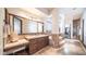 Luxurious bathroom with double sinks, vanity area, stone tile floor, and walk-in shower at 2330 N Channing --, Mesa, AZ 85207