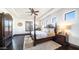 Main bedroom with canopy bed, decorative ceiling, wood floors, and plantation shutters at 2330 N Channing --, Mesa, AZ 85207