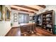 Home office featuring a large wood executive desk, wood beam ceiling, and built in bookcase at 2330 N Channing --, Mesa, AZ 85207