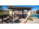 Outdoor kitchen and bar area under a pergola, perfect for poolside entertaining at 2330 N Channing --, Mesa, AZ 85207