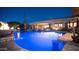 Beautiful pool with custom lighting, a swim up bar and fire bowls, perfect for evening relaxation at 2330 N Channing --, Mesa, AZ 85207