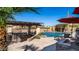Backyard pool and spa, accented by lush palm trees and desert landscaping at 2330 N Channing --, Mesa, AZ 85207