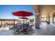 Inviting covered patio with red umbrellas, perfect for poolside dining and lounging at 2330 N Channing --, Mesa, AZ 85207