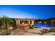 Gorgeous backyard pool with outdoor kitchen and bar, fire features and desert landscaping, at dusk at 2330 N Channing --, Mesa, AZ 85207