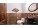 Stylish powder room featuring a unique vessel sink, dark wood vanity and designer accent wall at 2330 N Channing --, Mesa, AZ 85207