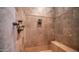 Close-up view of a shower with a built-in bench and travertine tile at 2330 N Channing --, Mesa, AZ 85207