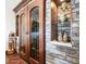 Close up of climate controlled wine cellar with beautiful stone accents and display shelving at 2330 N Channing --, Mesa, AZ 85207