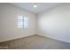 Neutral carpeted bedroom with a ceiling fan and window with blinds allowing natural light at 3128 E Cheryl Dr, Phoenix, AZ 85028