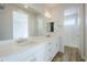 A spacious main bathroom, including dual sinks, a vanity, and a walk-in shower with bright lighting at 3128 E Cheryl Dr, Phoenix, AZ 85028