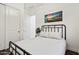 Bright bedroom with a black metal bed frame, neutral bedding, closet, and an interesting art piece at 35241 N Covelite Way, Queen Creek, AZ 85142