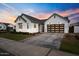 Charming single-Gathering home featuring a well-manicured lawn, a large garage, and a neutral color palette at 35241 N Covelite Way, Queen Creek, AZ 85142