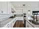 Open kitchen has subway tile backsplash, modern appliances, and wood flooring at 35241 N Covelite Way, Queen Creek, AZ 85142