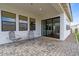 Covered outdoor patio featuring paved flooring, seating, and sliding glass doors leading to the interior at 35241 N Covelite Way, Queen Creek, AZ 85142