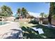 Lush backyard with sparkling pool, manicured lawn, outdoor games, and comfortable lounge area at 3726 S Juniper St, Tempe, AZ 85282