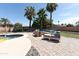 Charming backyard featuring a spacious patio, outdoor seating, lush lawn, and mature palm trees at 3726 S Juniper St, Tempe, AZ 85282