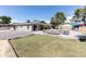 Expansive backyard with pool, patio seating, lush lawn, and mature trees creating a private oasis at 3726 S Juniper St, Tempe, AZ 85282