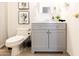Cozy bathroom features a gray vanity, a toilet with a white seat, and decorative plants at 3726 S Juniper St, Tempe, AZ 85282