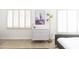 A bright bedroom featuring wooden floors and a chest of drawers by a window at 3726 S Juniper St, Tempe, AZ 85282