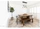 Dining space with a rustic wood table, woven chairs, bench, and modern chandelier at 3726 S Juniper St, Tempe, AZ 85282