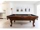 Close-up of a pool table in a well-lit game room, accented with wall art at 3726 S Juniper St, Tempe, AZ 85282