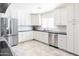 Bright kitchen with white cabinets, stainless steel appliances, and dark countertops at 3726 S Juniper St, Tempe, AZ 85282