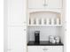 Kitchen coffee bar area with white subway tile, Keurig coffee maker, and white cabinets at 3726 S Juniper St, Tempe, AZ 85282
