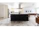 Bright kitchen features a dark island, a large counter with bar seating, and neutral tile floors at 3726 S Juniper St, Tempe, AZ 85282