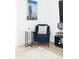 Cozy corner with a blue armchair, accent table, and Arizona-themed wall art at 3726 S Juniper St, Tempe, AZ 85282