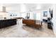 Open-concept living room with a leather sofa, neutral decor, and a view of the kitchen at 3726 S Juniper St, Tempe, AZ 85282