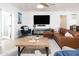 Bright living room with a brown leather couch, wood coffee table, and stylish decor at 3726 S Juniper St, Tempe, AZ 85282