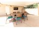 Covered patio dining area with a wooden table, comfortable seating, and an outdoor television at 3726 S Juniper St, Tempe, AZ 85282