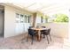 Charming outdoor patio with a round wooden table and seating for four, perfect for entertaining or relaxing at 3726 S Juniper St, Tempe, AZ 85282