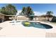 Sparkling pool with unicorn float, surrounded by patio, lounge chairs, and lush landscaping at 3726 S Juniper St, Tempe, AZ 85282