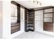 A spacious walk-in closet boasts custom dark wood shelving with drawers for optimal storage at 3726 S Juniper St, Tempe, AZ 85282