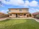 A well maintained backyard with an artificial lawn and covered patio at 3732 E South Fork Dr, Phoenix, AZ 85044